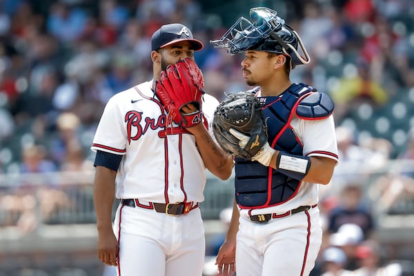 Reynaldo Lopez (left) hashes things out with catcher Drake Baldwin during a recent relief appearance. (Erik S. Lesser/AP)