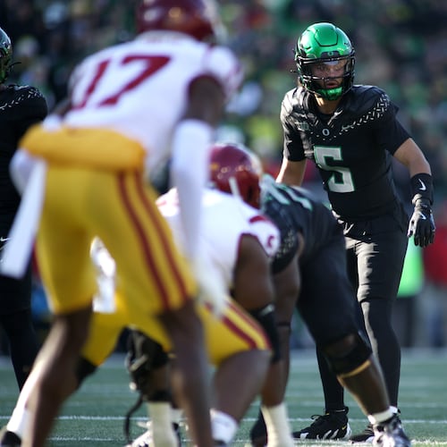 Oregon quarterback Dante Moore (5) calls instructions during the first half of an NCAA college football game against Southern California, Saturday, Nov. 22, 2025, in Eugene, Ore. (AP Photo/Lydia Ely)