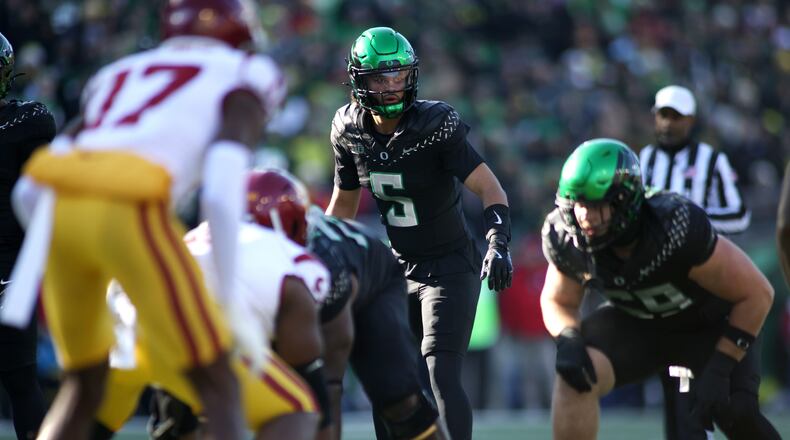 Oregon quarterback Dante Moore (5) calls instructions during the first half of an NCAA college football game against Southern California, Saturday, Nov. 22, 2025, in Eugene, Ore. (AP Photo/Lydia Ely)