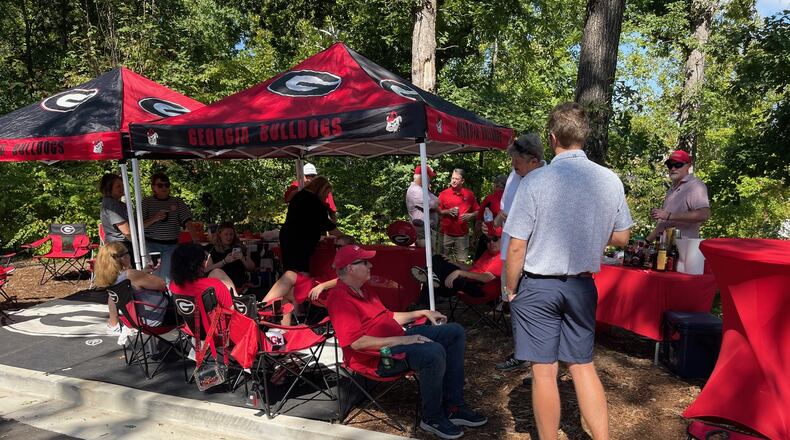 It's very early on the morning of Georgia games when fans arrive to begin the Saturday ritual of setting up tailgates. UGA campus does not open its doors to tailgaters until 7 a.m. This is the "Take No Prisoners" tailgate on Field Street, just outside Gate 8A at Sanford Stadium, on Oct. 5, 2024. (Photo by Chip Towers/ctowers@ajc.com)