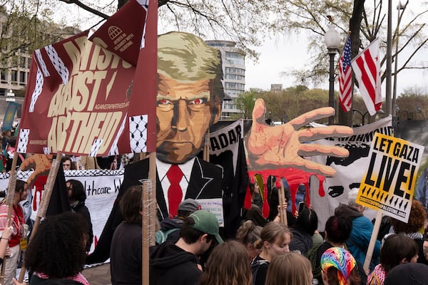 Pro-Palestinian protesters carrying a depiction of President Donald Trump gather at a rally before marching toward the U.S. Immigration and Customs Enforcement (ICE) headquarters, Saturday, April 5, 2025, in Washington. (AP Photo/Manuel Balce Ceneta)