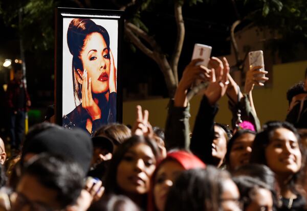 FILE - A portrait of the late singer Selena Quintanilla is seen in the crowd following a posthumous star ceremony for Quintanilla on the Hollywood Walk of Fame on Friday, Nov. 3, 2017, in Los Angeles. (Photo by Chris Pizzello/Invision/AP, File)
