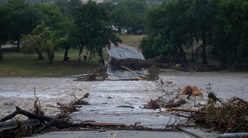Flooding blocks off G Street along the Guadalupe River on Thursday, July 16, 2026, in Kerrville, Texas. (AP Photo/Joel Angel Juarez)
