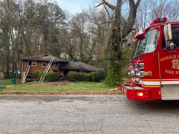 A DeKalb County woman died Sunday evening, one day after firefighters pulled her from a burning home in the Gresham Park neighborhood. 