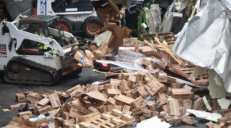 September 25, 2015 Atlanta, GA: Officials clean up the scene on GA 400 North bound where two trucks fell Friday September 25, 20115. A Publix truck carrying a load of candy bars and M&M's overturned on GA 400 Northbound. A second truck, carrying fuel. turned over on the embankment. Both drivers suffered non-life threatening injuries