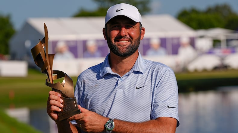 Scottie Scheffler holds the winning trophy after the final round of the St. Jude Championship golf tournament, Sunday, Aug. 16, 2026, in Memphis, Tenn. (AP Photo/George Walker IV)