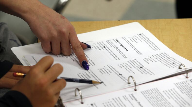Katerina Maylock, with Capitals Educators, points on a student’s worksheet as she teaches a test-preparation class at Holton Arms School, Sunday, Jan. 17, 2016 in Bethesda, Md. Alex Brandon / Associated Press