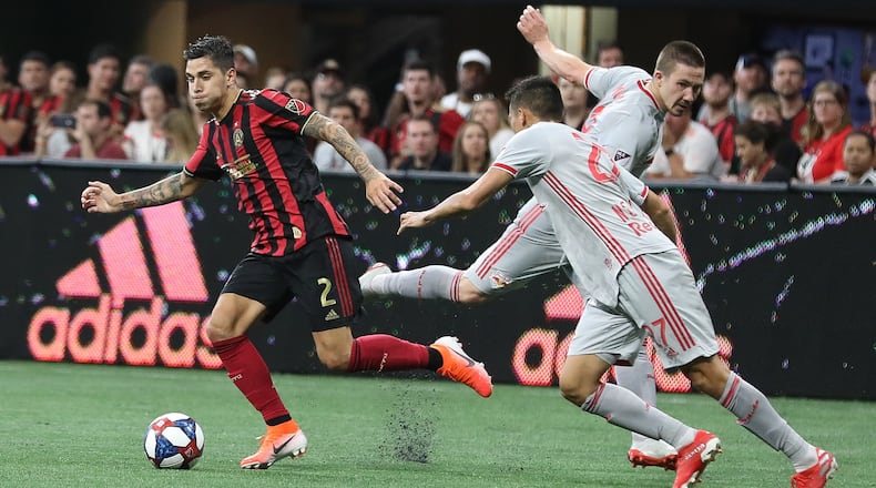 Atlanta United defender Franco Escobar (2) moves the ball past New York City Red Bulls players during the first half of a MLS game on Sunday, July 7, 2019, in Atlanta. Branden Camp/SPECIAL