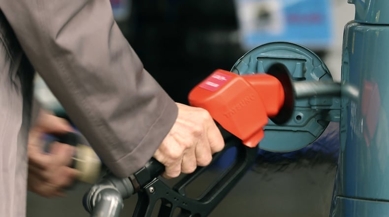 A customer fills up the tank of a vehicle at a gasoline station in Tokyo, on March 18, 2026. (Naoki Kawano/Kyodo News via AP)