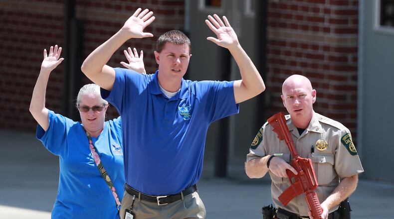 July 25, 2018 Winston: A law enforcement officer helps evacuate teachers and students during an active shooter training exercise held by the Douglas County Sheriff's Office at Mason Creek Middle School on Wednesday, July 25, 2018, in Winston. The large scale training drill is meant to test the resources of area law enforcement and emergency responders in an effort to better prepare Douglas County First Responders in the event of a mass casualty active shooter event.   Curtis Compton/ccompton@ajc.com