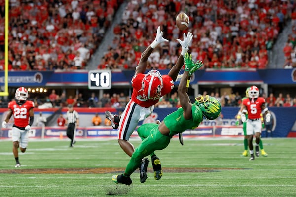 Georgia Bulldogs defensive back Malaki Starks (24) intercepts a pass intended for Oregon Ducks wide receiver Seven McGee (7) during the first quarter in the Chick-fil-A Kickoff game at Mercedes Benz Stadium, Saturday, September 3, 2022, in Atlanta. (Jason Getz / Jason.Getz@ajc.com)