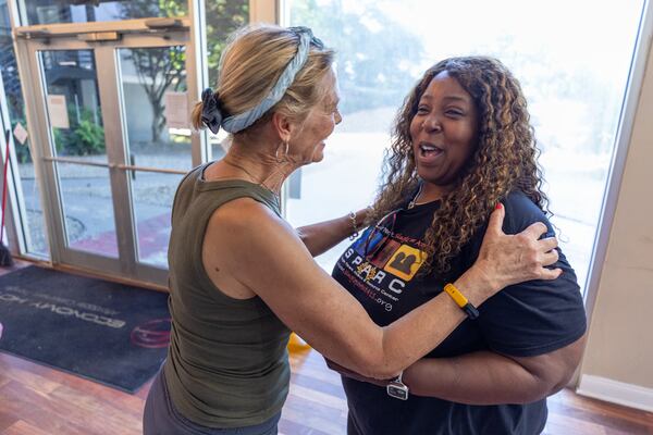 Activist Sue Sullivan and Joy Monroe, founder of The Single Parent Alliance & Resource Center, interact while delivering food and goods to residents of Economy Hotel in Marietta on Thursday, May 22, 2025. (Arvin Temkar/AJC)
