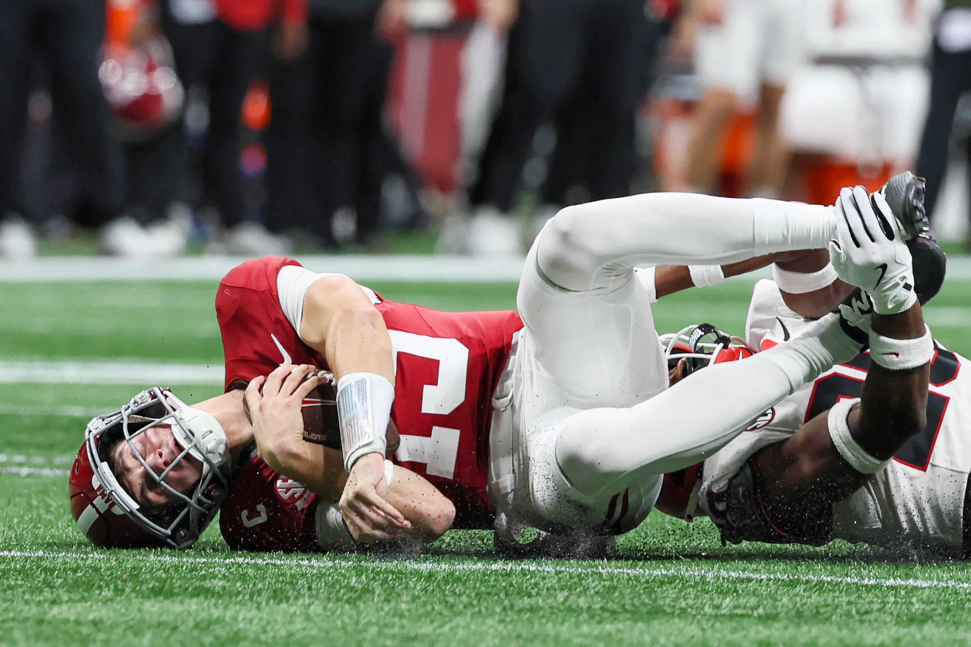 Alabama quarterback Ty Simpson (15) is sacked by Georgia defensive back Jacorey Thomas (20) during the third quarter of the SEC Championship game at Mercedes-Benz Stadium, Saturday, Dec. 6, 2025, in Atlanta. (Jason Getz / AJC)