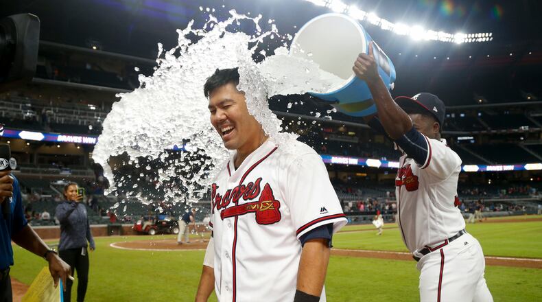 Atlanta Braves' Kurt Suzuki is doused by Arodys Vizcaino after a walk-off single in a baseball game against the Miami Marlins, Thursday, Sept. 7, 2017, in Atlanta. The Braves won 6-5. (AP Photo/Brett Davis)