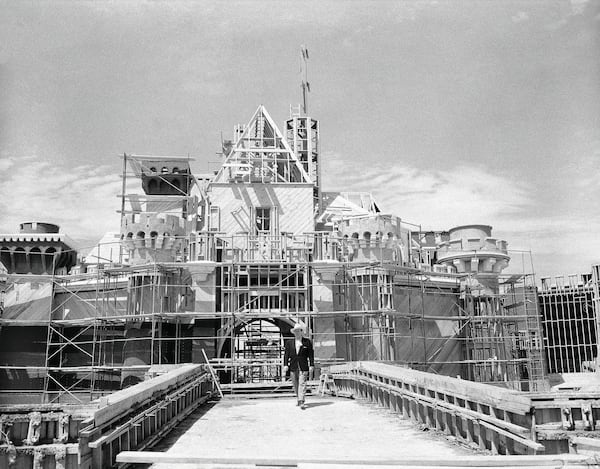 FILE - Walt Disney crosses the drawbridge that serves as the entrance to Sleeping Beauty Castle at Disneyland, in Anaheim, Calif., on April 16, 1955. (AP Photo/David F. Smith, File)