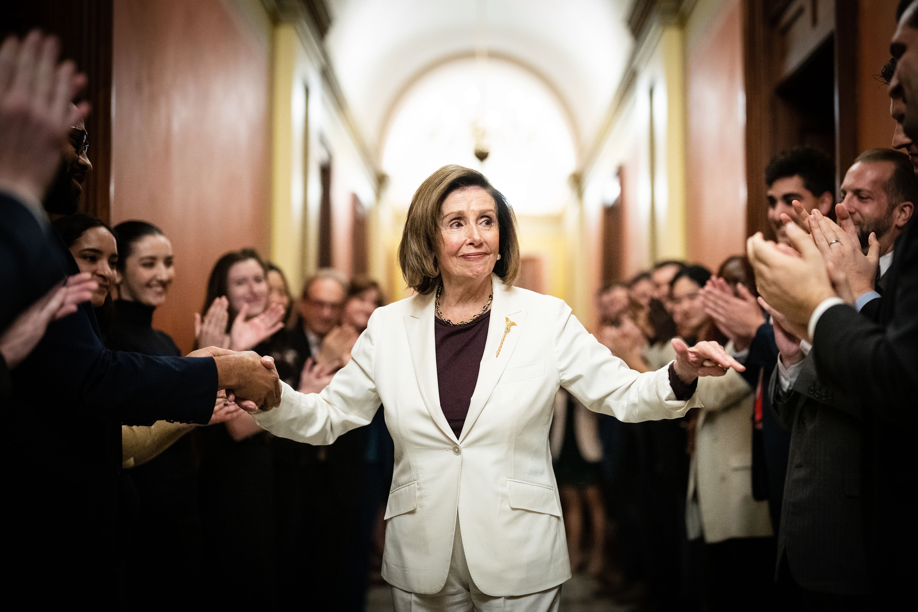 Nancy Pelosi, D-Calif., was greeted by staff in Washington after she announced she was stepping down as Democratic leader of the House. (Erin Schaff/The New York Times)