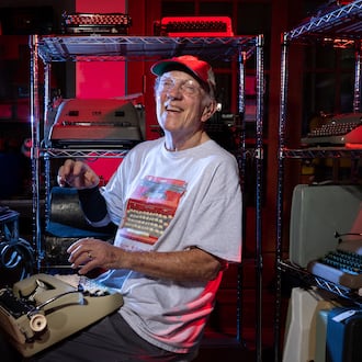 Tom Rehkopf poses for a portrait in his home workshop in Roswell on Sunday, October 5, 2025. Rehkopf has collected around 1,000 typewriters. (Arvin Temkar / AJC)