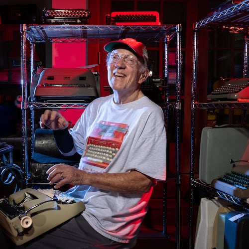 Tom Rehkopf poses for a portrait in his home workshop in Roswell on Sunday, October 5, 2025. Rehkopf has collected around 1,000 typewriters. (Arvin Temkar / AJC)