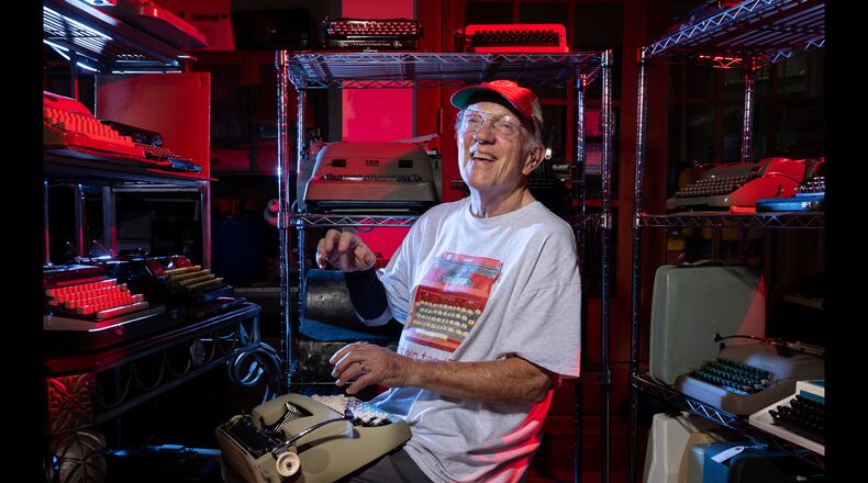 Tom Rehkopf poses for a portrait in his home workshop in Roswell on Sunday, October 5, 2025. Rehkopf has collected around 1,000 typewriters. (Arvin Temkar / AJC)
