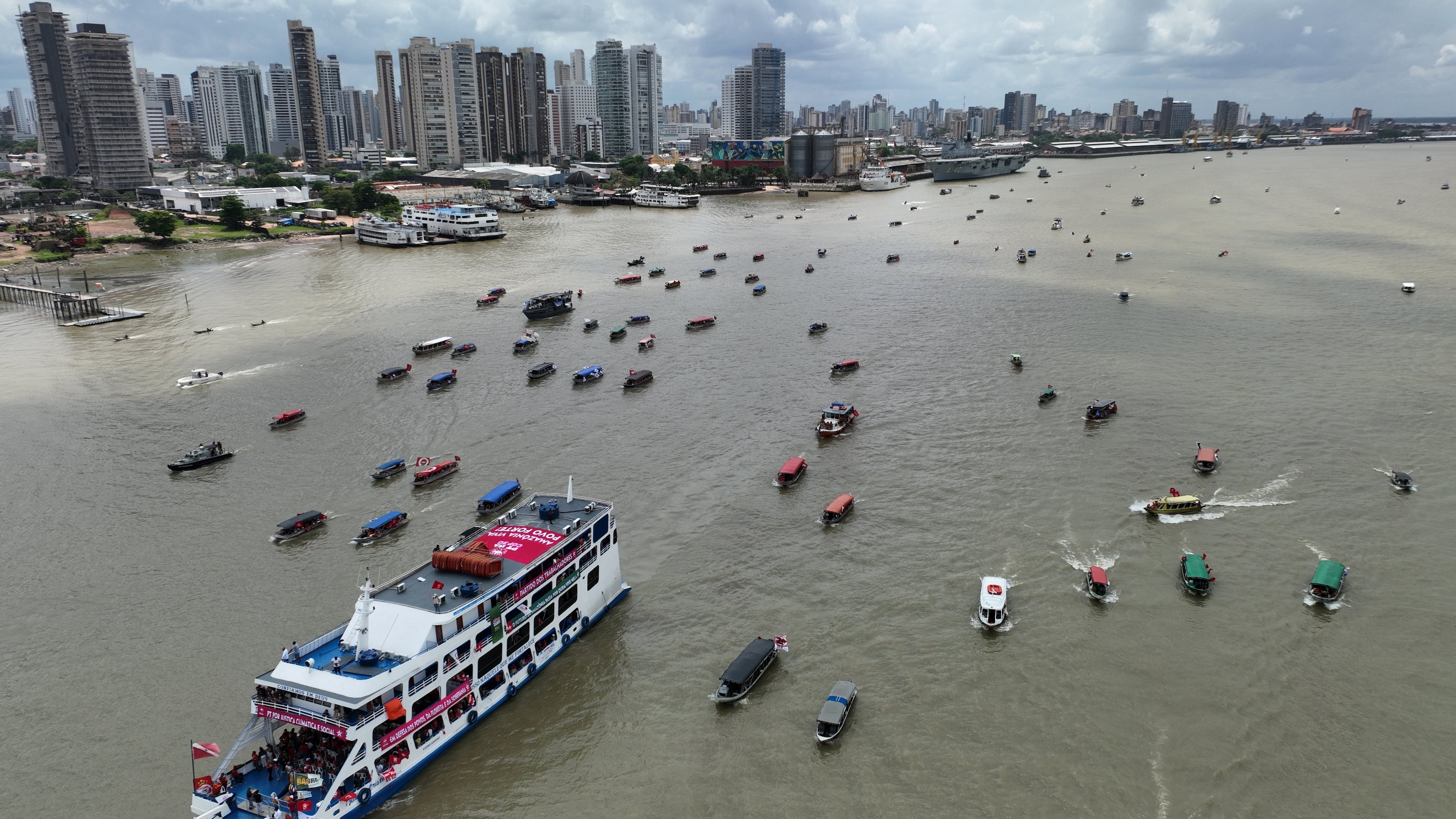 People riding in boats participate in a People's Summit event on Guajara Bay during the COP30 U.N. Climate Summit, Wednesday, Nov. 12, 2025, in Belem, Brazil. (AP Photo/Andre Penner)