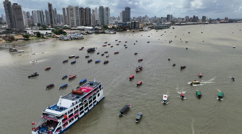 People riding in boats participate in a People's Summit event on Guajara Bay during the COP30 U.N. Climate Summit, Wednesday, Nov. 12, 2025, in Belem, Brazil. (AP Photo/Andre Penner)