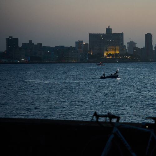 A man sits on the Malecón seawall after sunset during a blackout in Havana, Cuba, Tuesday, July 14, 2026. (AP Photo/Ramon Espinosa)