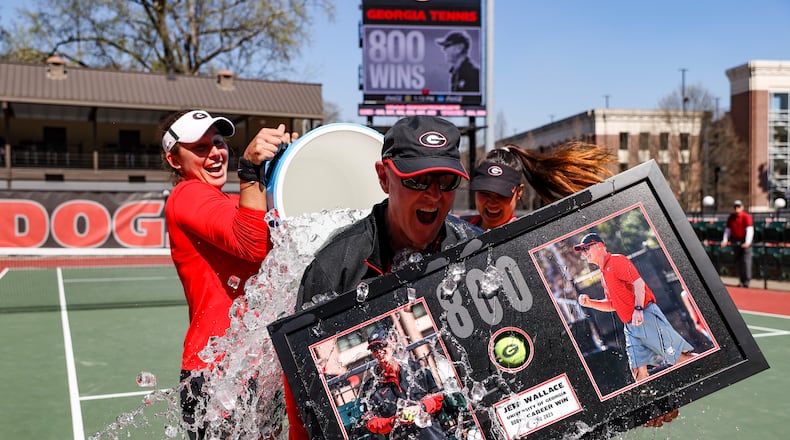Georgia coach Jeff Wallace gets a surprise water-cooler bath after the Bulldogs won the 800th match of his career as the women's tennis coach against Missouri at Henry Feild Stadium at the Dan Magill Tennis Complex in Athens, on Sunday, March 5, 2023. Wallace, who has since won 14 more matches, announced his retirement Friday after 38 years on the job. (Kayla Renie/UGA Athletics)