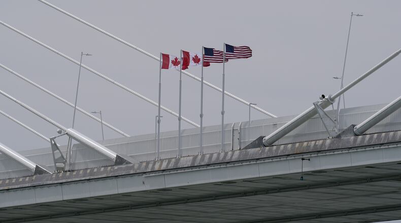 FILE - Canadian and American flags are shown on the Gordie Howe Bridge under construction between Windsor, Ontario and Detroit, May 22, 2026. (AP Photo/Paul Sancya, File)