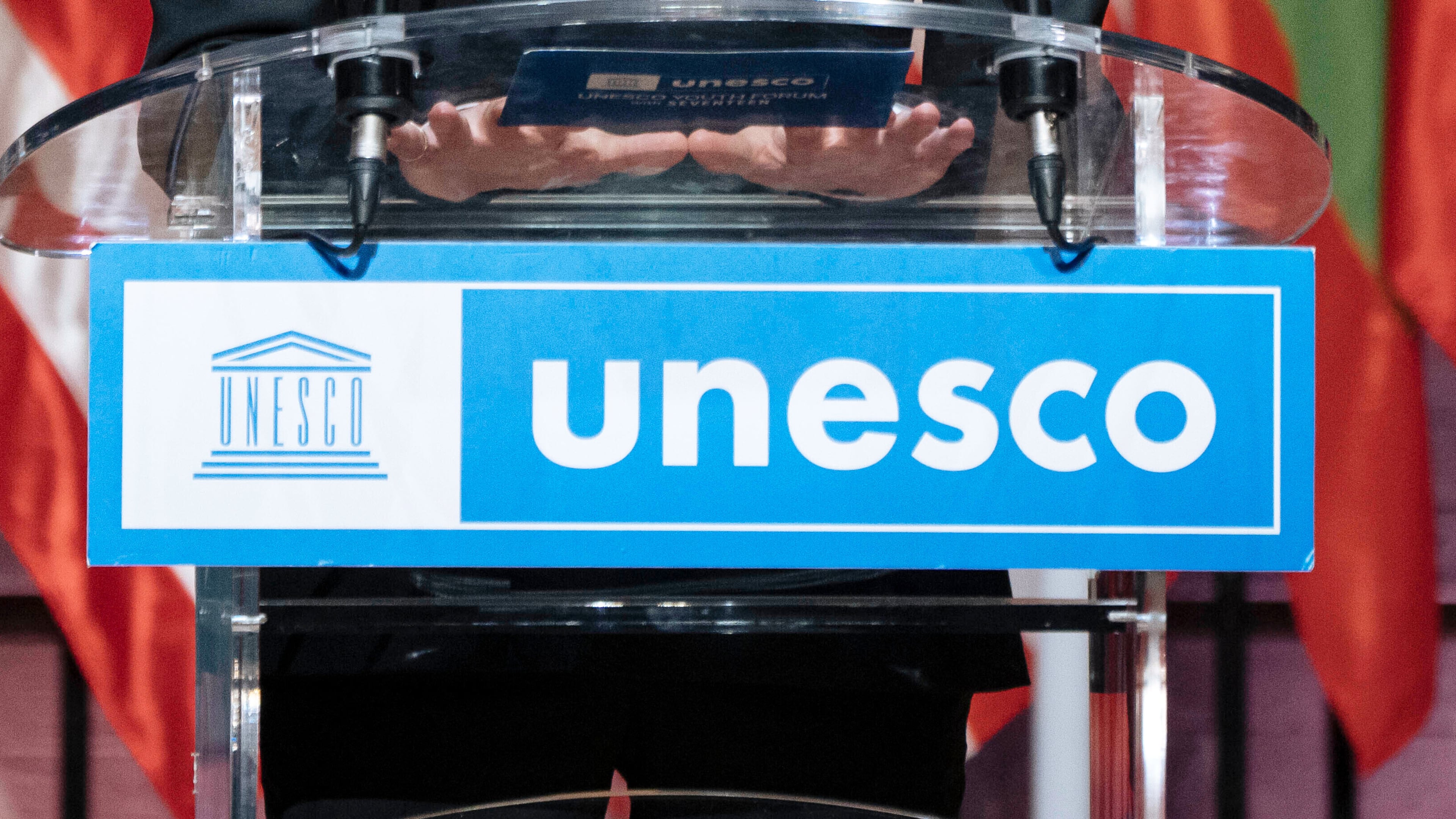 FILE - The UNESCO logo hangs from a podium in Paris, Nov. 14, 2023. (AP Photo/Lewis Joly, File)