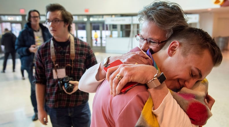 JJ Warren of New York embraces Julie Arms Meeks of Atlanta during protests outside the United Methodist Church's 2019 Special Session of the General Conference in St. Louis, Mo., Tuesday, Feb. 26, 2019. The United Methodist Church faces a likely surge in defections and defiance after delegates at a crucial conference voted to strengthen bans on same-sex marriage and ordination of LGBT clergy. (AP Photo/Sid Hastings)