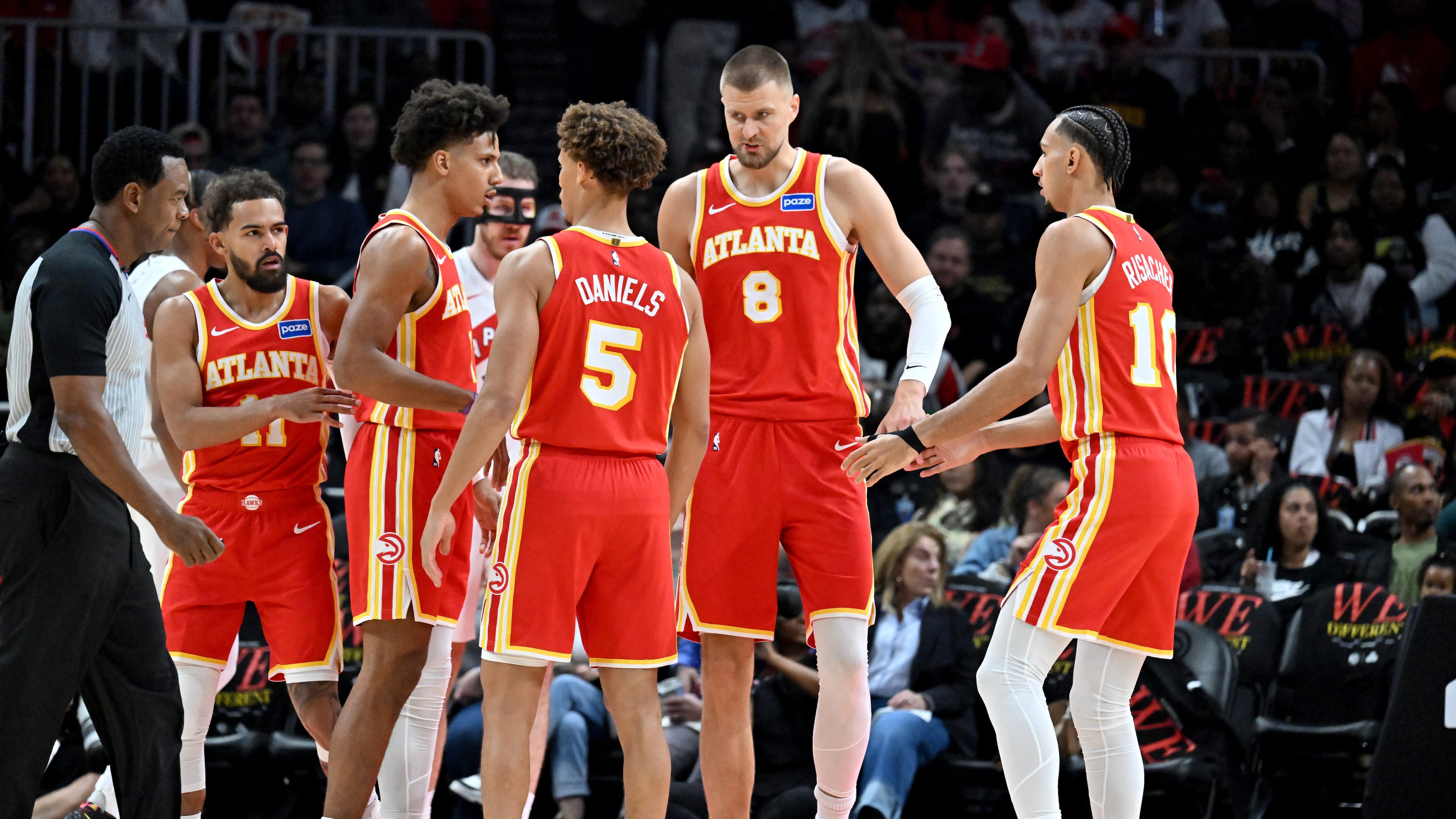 The Hawks confer during the first half in the home opener at State Farm Arena in October. (Hyosub Shin/AJC)