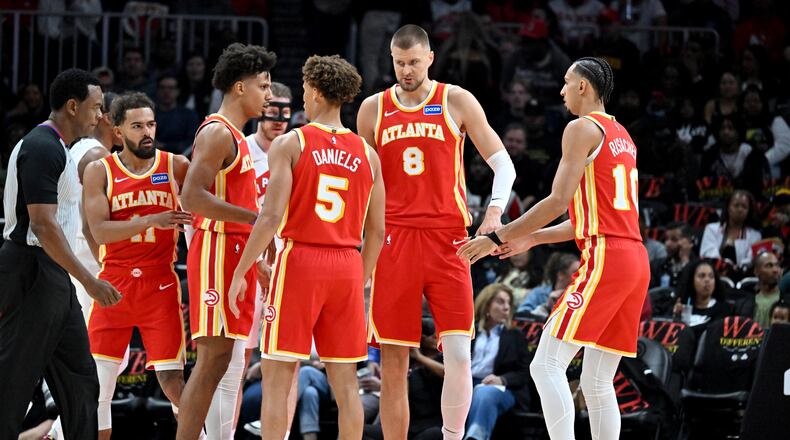 The Hawks confer during the first half in the home opener at State Farm Arena in October. (Hyosub Shin/AJC)