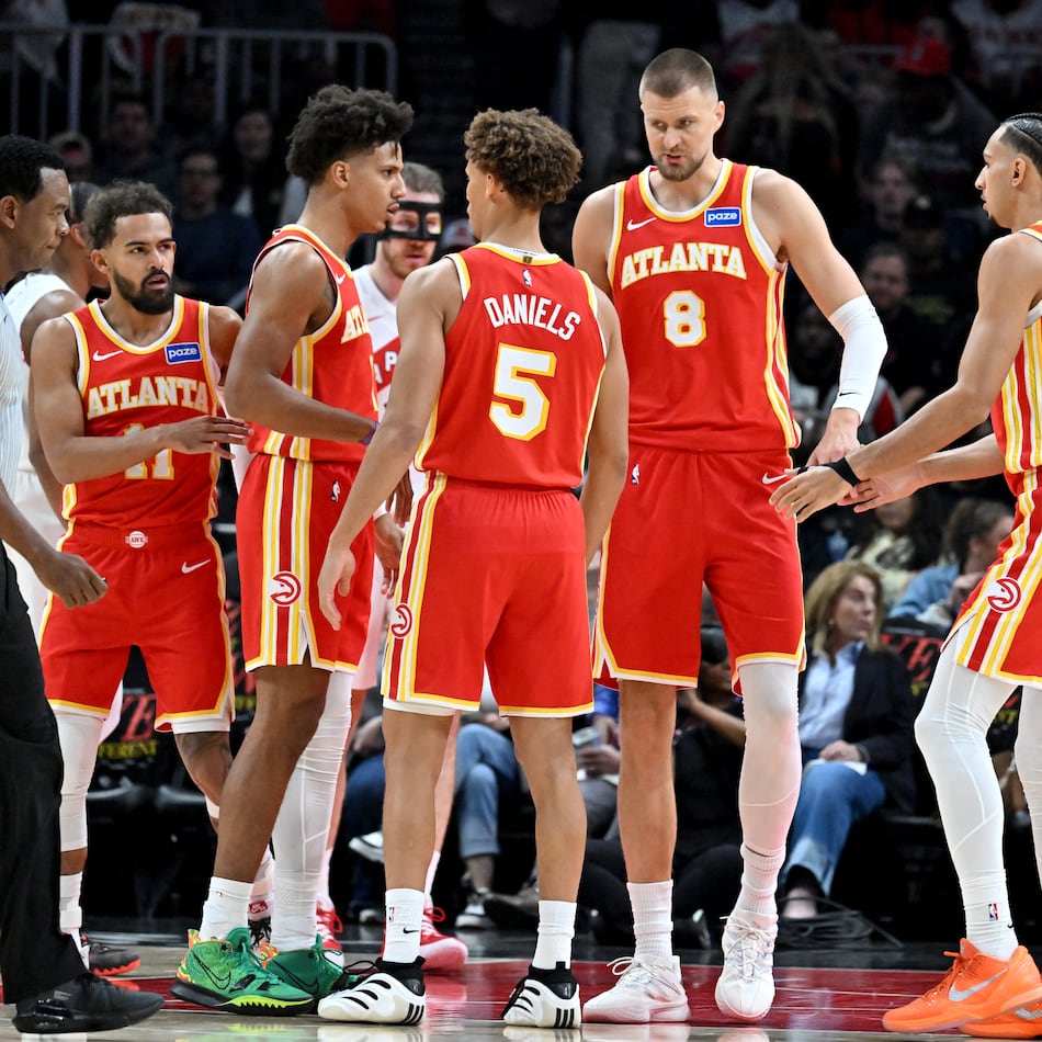 The Hawks confer during the first half in the home opener at State Farm Arena in October. (Hyosub Shin/AJC)