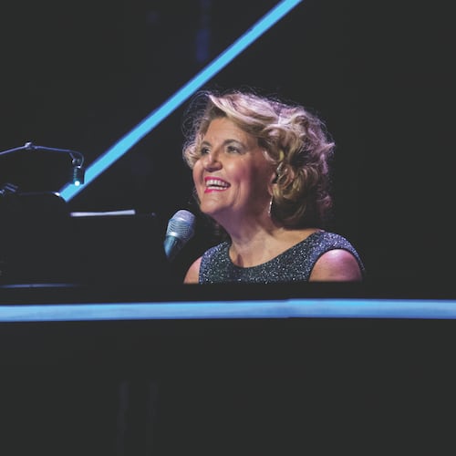 Ann-Carol Pence has served as “Christmas Canteen’s” music director, arranger and conductor for 30 years. Mixing music, comedy skits and dance numbers, the Aurora Theatre holiday show continues through Dec. 21. (Photo by Casey Gardner Ford)