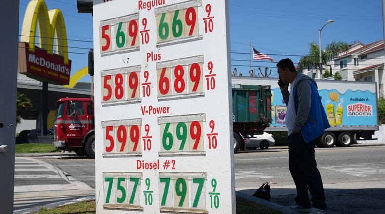 Gas prices are displayed at a gasoline station, Tuesday, April 7, 2026, in Los Angeles. (AP Photo/Damian Dovarganes)