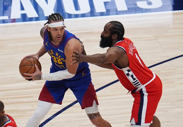 Denver Nuggets forward Aaron Gordon, left, looks to pass the ball as Los Angeles Clippers guard James Harden defends in the first half of Game 1 of an NBA first-round playoff series Saturday, April 19, 2025, in Denver. (AP Photo/David Zalubowski)