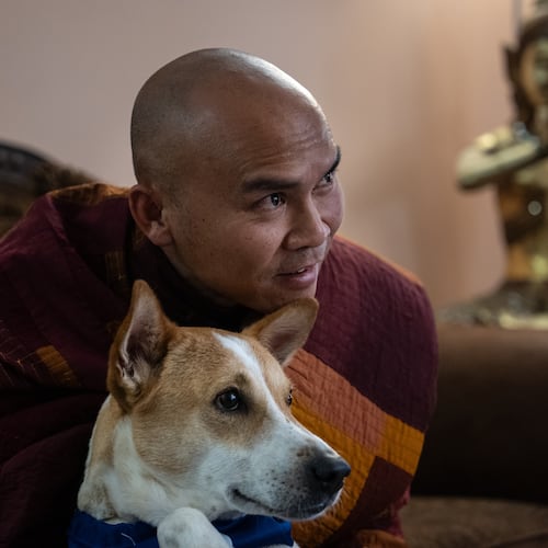 Bhikkhu Pannakara, a Buddhist monk who led a Walk for Peace from Fort Worth, Texas, to Washington, D.C., sits with his dog, Aloka, before an event at Wat Thai of Los Angeles in the North Hollywood section of Los Angeles, Monday, July 13, 2026. (AP Photo/Jae C. Hong)