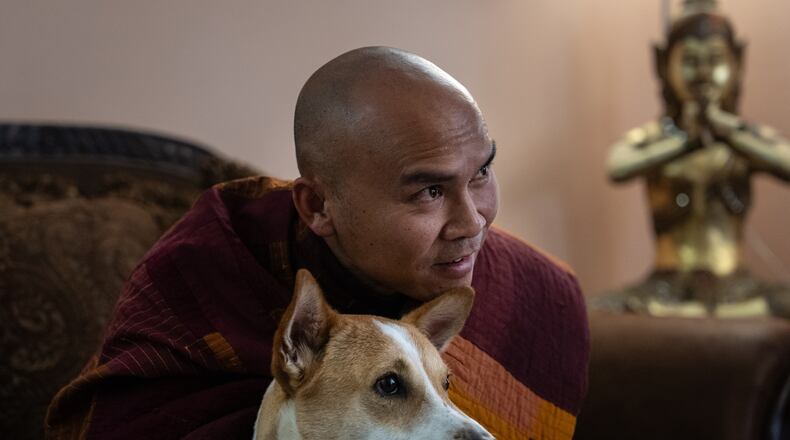 Bhikkhu Pannakara, a Buddhist monk who led a Walk for Peace from Fort Worth, Texas, to Washington, D.C., sits with his dog, Aloka, before an event at Wat Thai of Los Angeles in the North Hollywood section of Los Angeles, Monday, July 13, 2026. (AP Photo/Jae C. Hong)