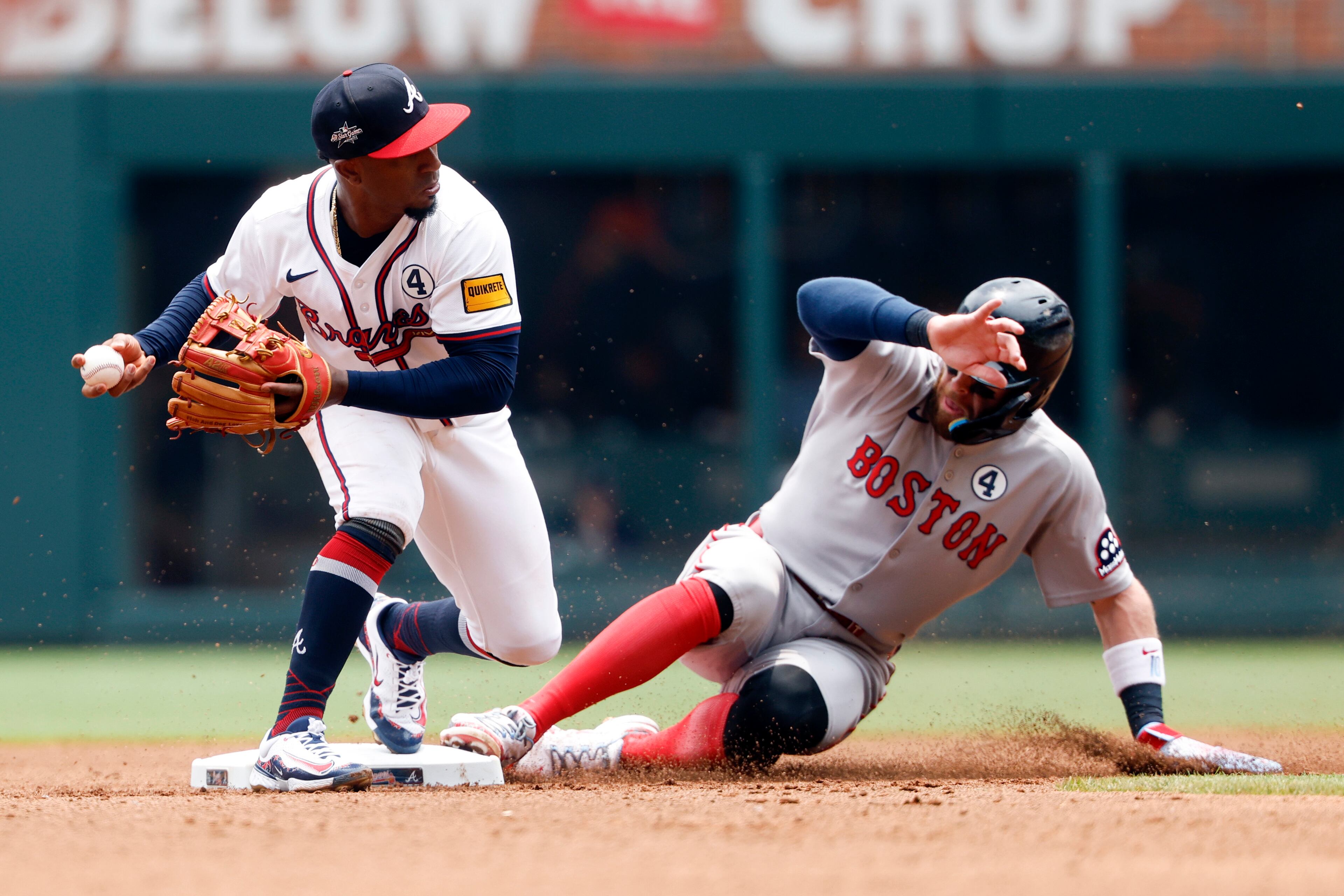 Atlanta Braves second baseman Ozzie Albies (1) gets the force out on Boston Red Sox's Trevor Story (10) as he slides into second base during the fourth inning of a baseball game, Sunday, June 1, 2025, in Atlanta. (AP Photo/Butch Dill)