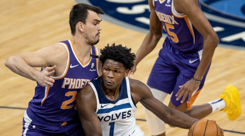 Wolves guard Anthony Edwards drove against the Suns Dario Saric in the first quarter Sunday. (Carlos Gonzalez/Star Tribune/TNS)