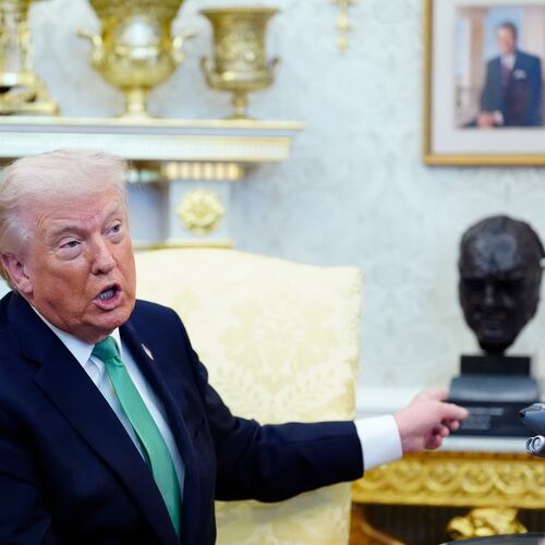 President Donald Trump points to a bust of Winston Churchill as he speaks during a meeting with Irish Prime Minister Micheál Martin in the Oval Office of the White House, on St. Patrick's Day, Tuesday, March 17, 2026, in Washington. (AP Photo/Alex Brandon)