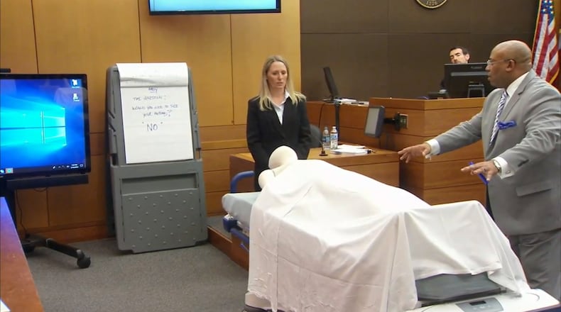 Dr. Susanne Hardy of Emory Hospital and lead prosecutor Clint Rucker use a stretcher with a manequin to demonstrate to the jury how Hardy was postitioned next to Diane McIver. The demonstration was part of Hardy's testimony during the Tex McIver murder trial on March 16, 2018 at the Fulton County Courthouse. (Channel 2 Action News)