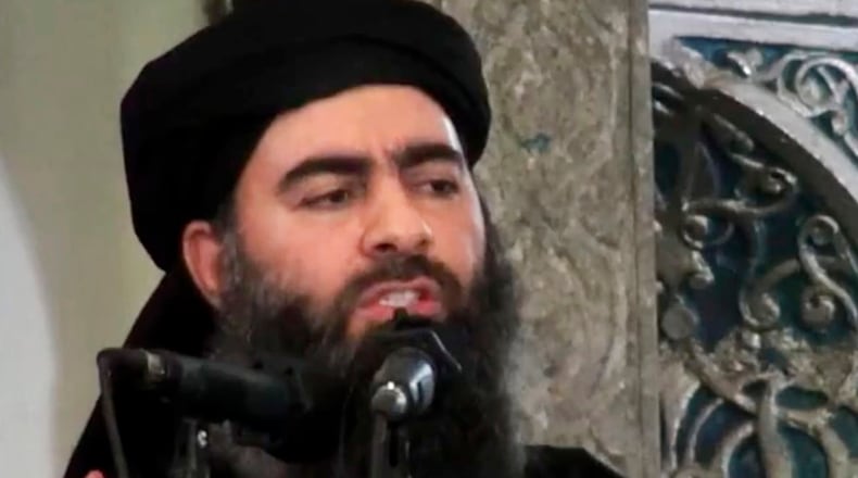 This file image made from video posted on a militant website Saturday, July 5, 2014, purports to show the leader of the Islamic State group, Abu Bakr al-Baghdadi, delivering a sermon at a mosque in Iraq during his first public appearance.