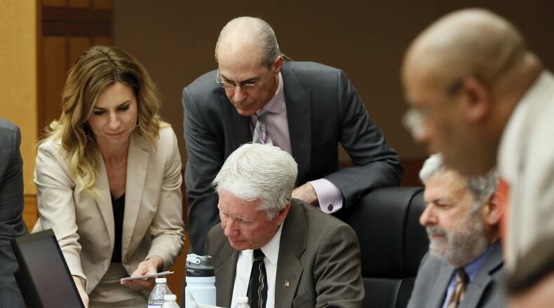 Tex McIver (seated) is surrounded by attorneys Amanda Clark Palmer, Bruce Harvey, Don Samuel (seated, to McIver’s left) and Clint Rucker as they review questions wants to ask of a witness. Bob Andres / bandres@ajc.com