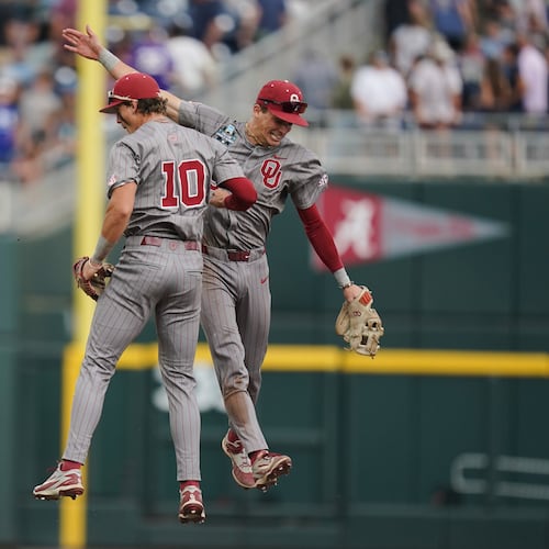 Oklahoma catcher Brendan Brock (10) and infielder Kyle Branch (6) celebrate after an NCAA baseball College World Series game, Saturday, June 13, 2026 in Omaha, Neb. Oklahoma won 9-0. (AP Photo/Vera Nieuwenhuis)