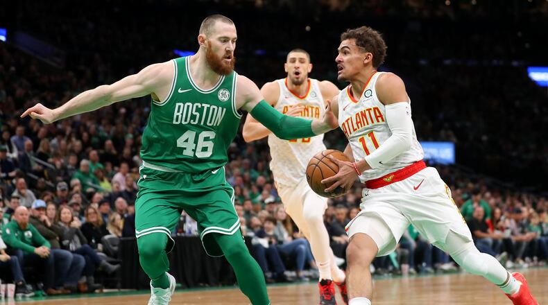 Trae Young (right) of the Hawks drives against Aron Baynes of the Boston Celtics. (Photo by Maddie Meyer/Getty Images)