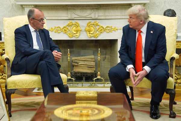 President Donald Trump, right, listens during a meeting with Germany's Chancellor Friedrich Merz in the Oval Office of the White House, Thursday, June 5, 2025, in Washington. (AP Photo/Evan Vucci)