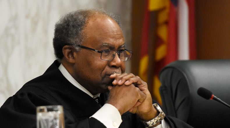 Justice Robert Benham, seen here listening to oral arguments in 2017, said Thursday he will retire from the court on March 1, 2020. (DAVID BARNES / DAVID.BARNES@AJC.COM)