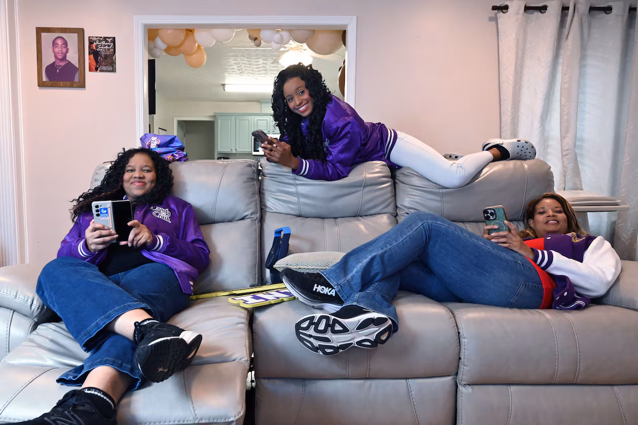 Selita Boyd, left, her sister Aalja Boyd, right, and her niece Jemini Powell, center, pose as they do when playing Candy Crush on Tuesday, Aug. 4, 2026, in Stone Mountain. All three have competed in a $1 million Candy Crush tournament, where the top 10 players compete. (Hyosub Shin/AJC)