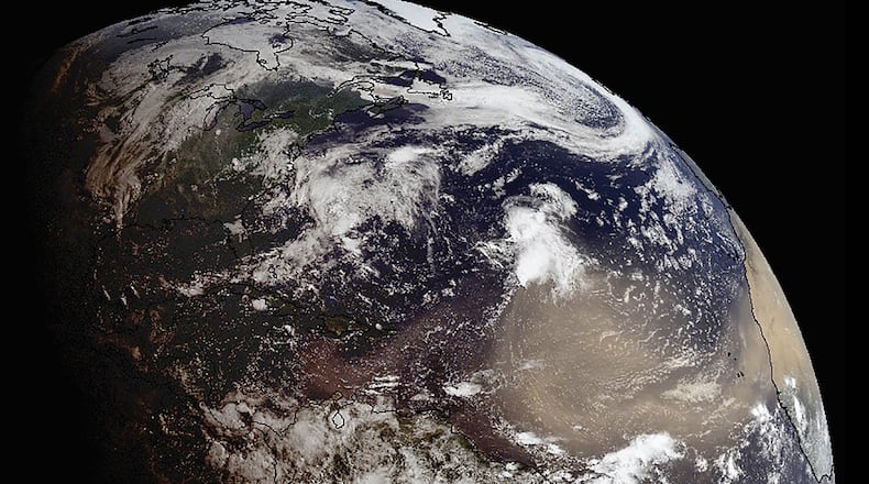 In a photo provided by NOAA, a giant plume of Saharan dust on a 5,000-mile journey is expected to drift across the southeastern United States this week at altitudes between 20,000 and 30,000 feet, bringing enhanced sunrises and potentially suppressing storm formation.